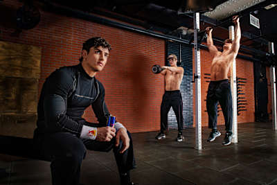 A composite photo of Victor Hoffer from a photoshoot for the Red Bulletin, featuring two images of him working out, with a larger image of him drinking a can of Red Bull in the foreground