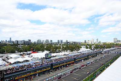 The pit lane housing the team garages with the paddock behind