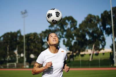 Deyna Castellanos heads a soccer ball in Los Angeles, California