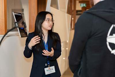 Joi Lam Chow speaks animatedly at Red Bull Canada HQ in Toronto for the Red Bull Basement Canada National Final on May 15, 2026.
