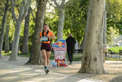 On April 26, 2026, a runner competes at Red Bull Flying Sprint during the Ultra Balaton event in Balatonfüred, Hungary, capturing the dynamism of Red Bull's signature running challenge