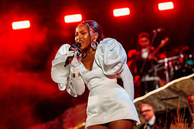 Zee Nxumalo lights up the stage with a powerful performance during Red Bull Symphonic in Johannesburg, South Africa on June 14, 2026, under dynamic red stage lights