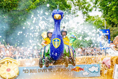 On 20th June 2026, Leeds United Football Club thrill crowds at Red Bull Soap Box in Alexandra Palace, London, racing their vibrant peacock-themed cart through bubbles and cheers