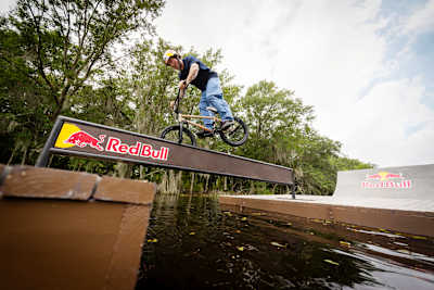 Broc Raiford rides a flat bar connecting floating docks in the bayou