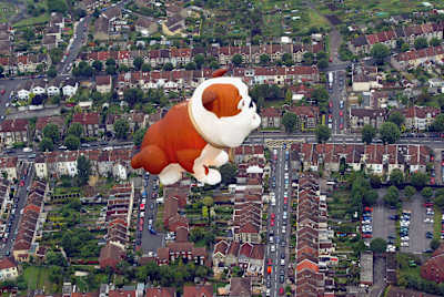 A dog-shaped hot air balloon rises over Bristol city centre, August 10, 2004 Bristol, England.
