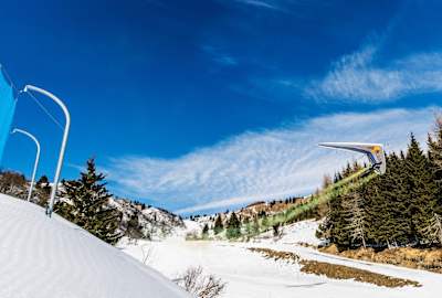 Matjaž Klemenčič performing during a speed run with his paraglider above a ski slope