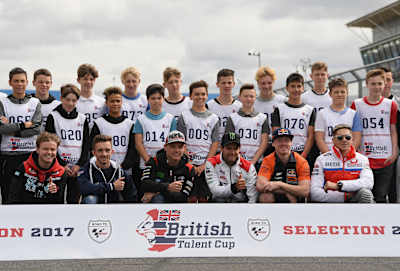 Riders from the British Talent Cup line up for a photo with MotoGP stars.