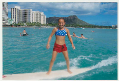 A photo of young a Carissa Moore riding waves