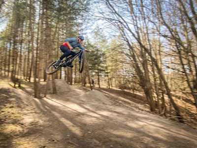 Steve Murphy hitting a big jump on his mountain bike in Hagaparken, Stockholm, Sweden in April 2021.