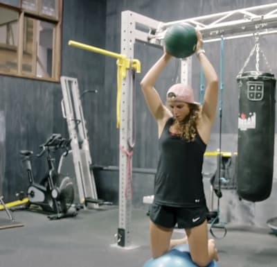Kneel on the ball and slam the medicine ball into the ground.