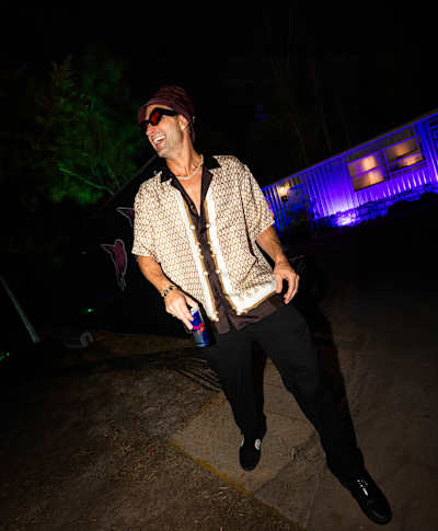 Australian DJ Fisher smiles and holds a can of Re dBull