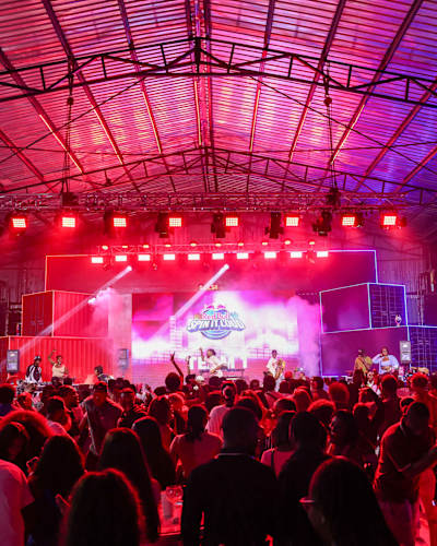 Crowds dance under vibrant lights at the Red Bull Spin it Loud event in Lagos, Nigeria, December 2024, with DJs and performers energising the packed venue in true Red Bull style
