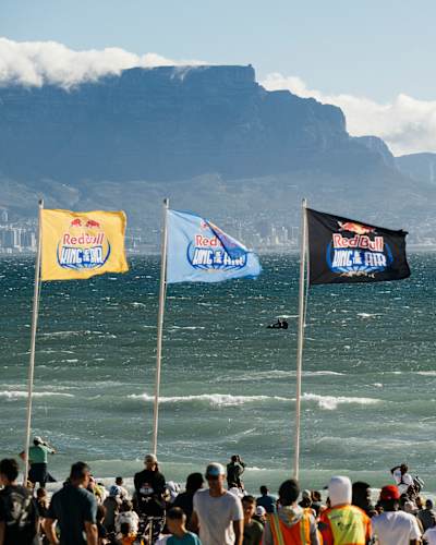 In 2024, Red Bull King Of The Air kitesurfing event at Cape Town's scenic beach with Table Mountain backdrop