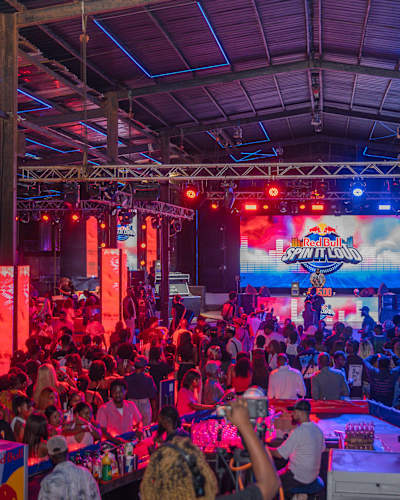 A vibrant crowd gathers for Red Bull Spin It Loud Nigeria 2025 at SOL Beach, Elegushi, in Lekki, Lagos, with dynamic lights and buzzing excitement on December 4th, 2025