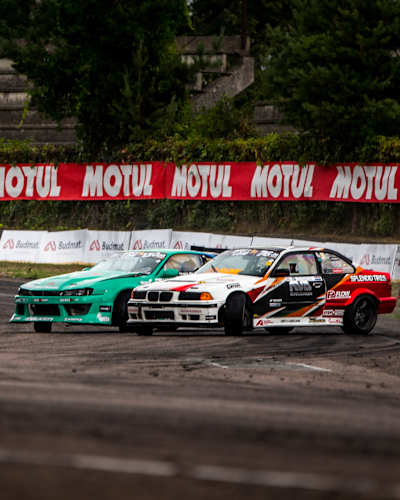 An image of two race cars at the Drift Masters European Championship.
