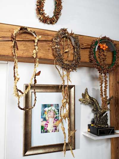 Wreaths and a photo of the finish line hang in her training room.