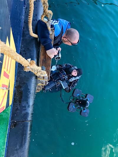 Max Struck takes a break from filming cliff diving for a warm drink.