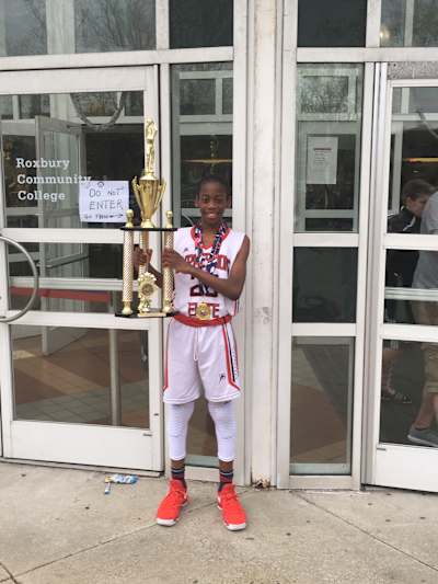 AJ Dybantsa as a child with his winning trophy