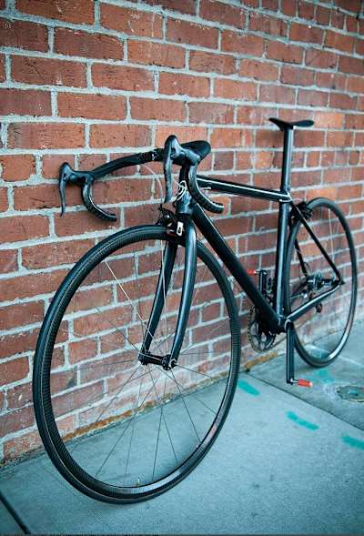 A close up of the handlebars and saddle on the world's lightest bike