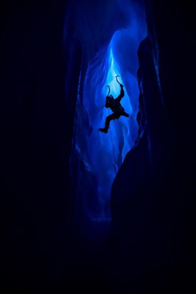Will Gadd is climbing in the darkness of the ice cave of the Athabasca Glacier in Canmore, Canada on January 3, 2017.