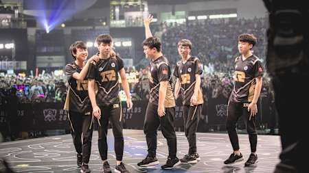 RNG celebrate their hard fought win on stage.