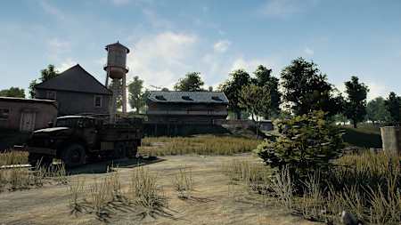 A promo image from PUBG showing some buildings, an old truck and trees.