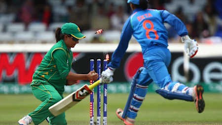 A batswoman gets run out as a player takes the Zing bells off the wicket