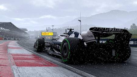 Screenshot from F1 22 shows an AlphaTauri on the start and finish straight of the Red Bull Ring in the rain