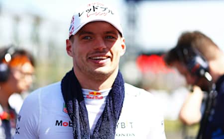 Max Verstappen with towel draped around neck as he looks onto the grid prior to the F1 Japan Grand Prix.