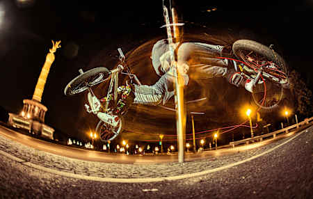 BMX freestyler Tim Knoll spins around a pole in Berlin, Germany on July 15, 2015