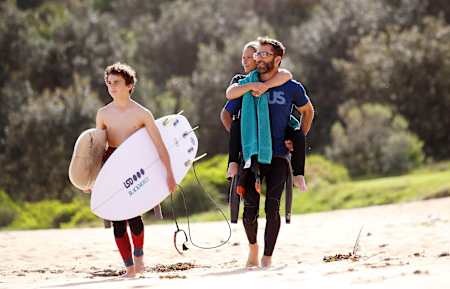 Sam and family head for the surf.