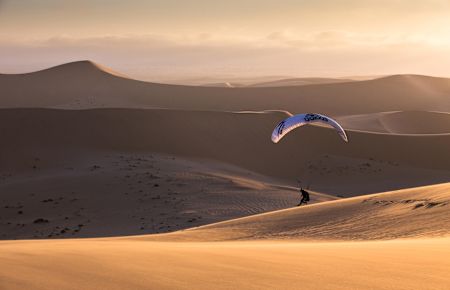 Paragliding on a sand dune in Namibia.