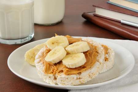 Maddie snacks on rice cakes with peanut butter and banana