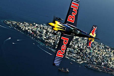 Close up of the top of Péter Besenyei's plane as he flies over Malé, Maldives, with the city and sea in the background in 2011.