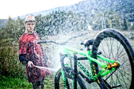A rider washes his mountain bike.