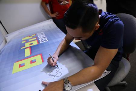 Jimmy "DeMoN" Ho Signing the 8-Bit eSports Club Banner