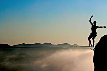Slacklining above the clouds in the mountains