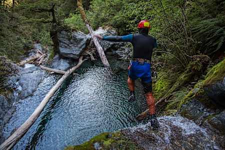 A Canyoner jumps into a water hole in a canyon in Wanaka, New Zealand.