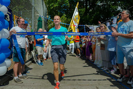 Ashprihanal Aalto crosses the finish line after runnng 3,100miles in a record-breaking 40 days
