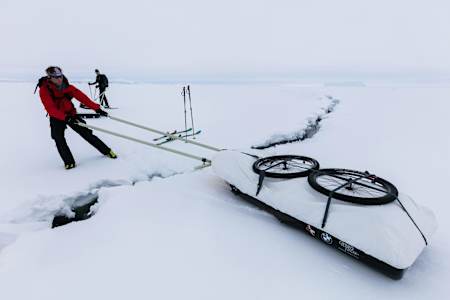 Stefan Glowacz pulls his sled across a crevasse.