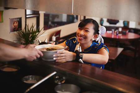 アツアツのラーメンを受け取り、満面の笑みを浮かべる春麗。