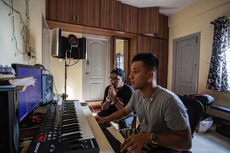 Rappers Gubbi and Big Deal work on music in Big Deal's home in Arekere, Bengaluru