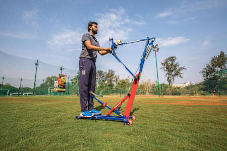 Pratheek Palenthra, the inventor, shows the Freebowler Superthrower, his invention.