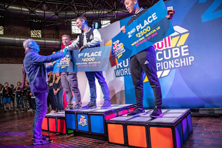 Winner Feliks Zemdegs gets congratulated by Rubik's Cube creator Erno Rubik.