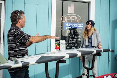 Jeff Clark presents Justine Dupont the new board he made for her in front of his shop in Half Moon Bay, United States on December 19th, 2014.