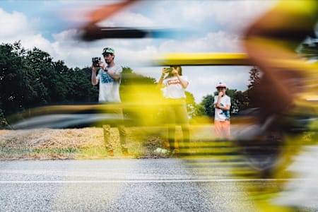 Cyclists rip past spectators at Tour de France, 2018