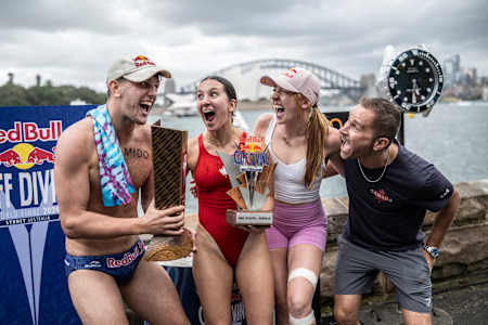 In 2024, Aidan Heslop, Simone Leathead and Molly Carlson celebrate at the Red Bull Cliff Diving World Series in Sydney