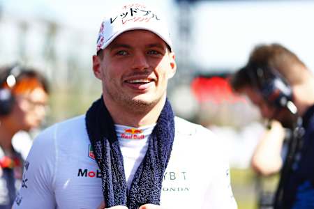 Max Verstappen with towel draped around neck as he looks onto the grid prior to the F1 Japan Grand Prix.