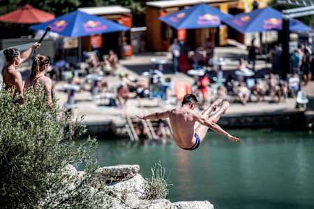 Jonathan Paredes of Mexico dives from the 20 metre cliff during the first competition day of the 2024 Red Bull Cliff Diving World Series at Lake Vouliagmeni in Athens, Greece on May 24, 2024.