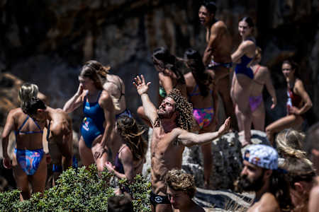 David Colturi (C) of the USA reacts amid the divers during the first stop of the Red Bull Cliff Diving World Series at Lake Vouliagmeni in Athens, Greece on May 23, 2024.